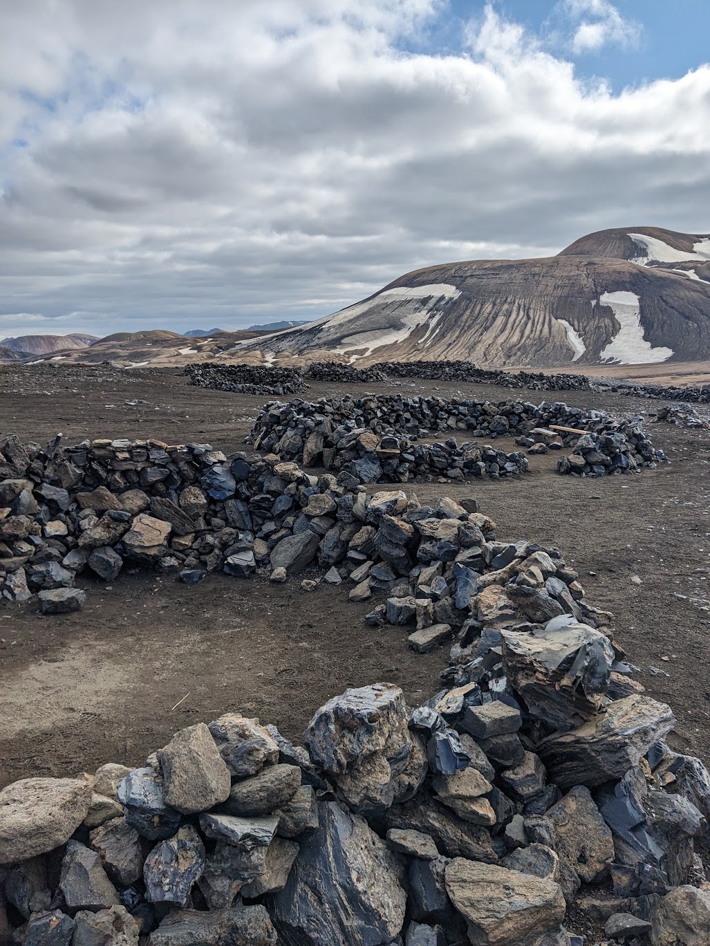A picture of the circular walls of rock and obsidian where campers can pitch their tents inside for some cover from the inevitable wind.